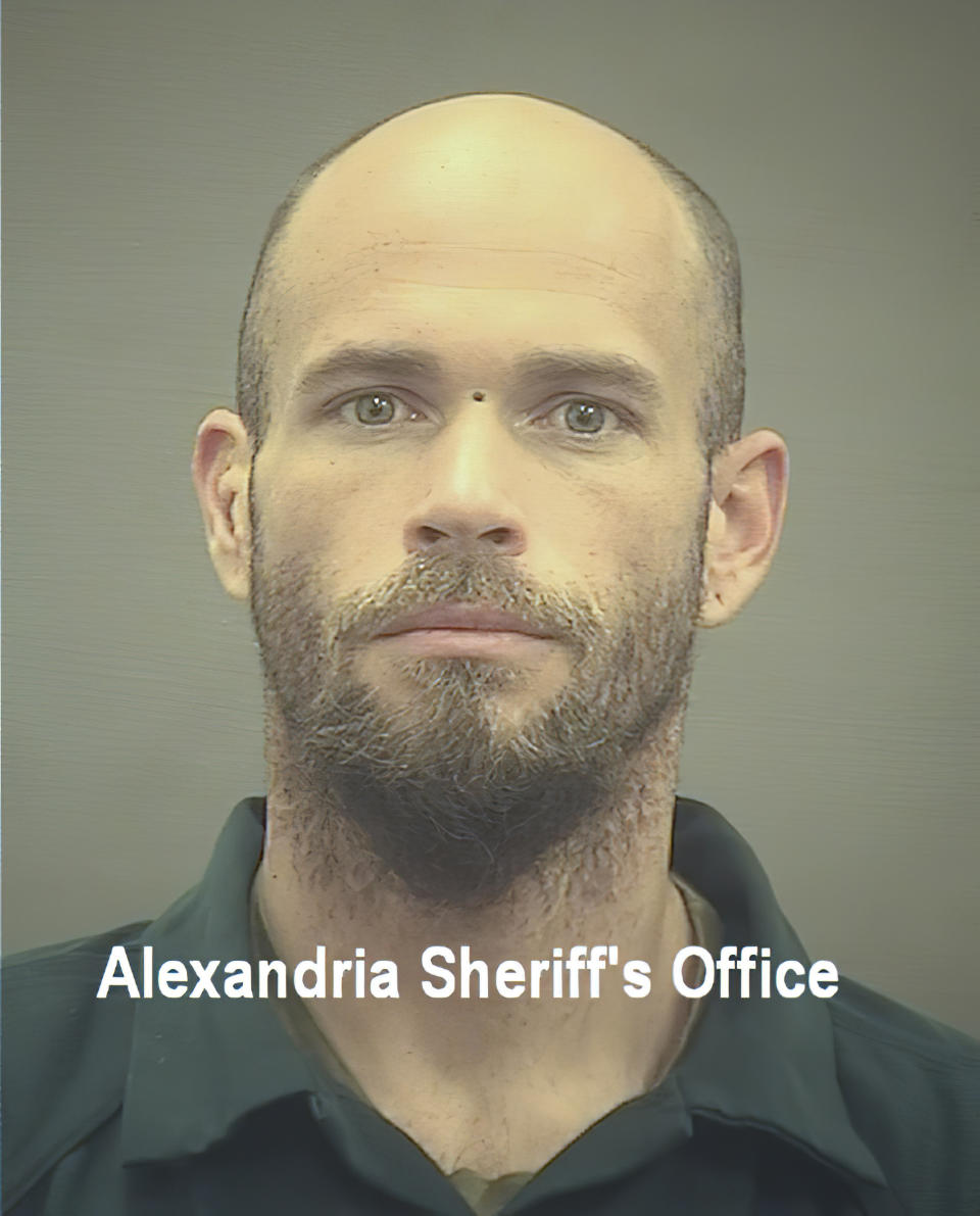 FILE - This image provided by The Alexandria (Va.) Sheriff's Office shows Jacob Chansley. Many of those who stormed the Capitol on Jan. 6 cited falsehoods about the election, and now some of them are hoping their gullibility helps them in court. Albert Watkins, the St. Louis attorney representing Chansley, the so-called QAnon shaman, likened the process to brainwashing, or falling into the clutches of a cult. Repeated exposure to falsehood and incendiary rhetoric, Watkins said, ultimately overwhelmed his client's ability to discern reality. (Alexandria Sheriff's Office via AP, FIle)