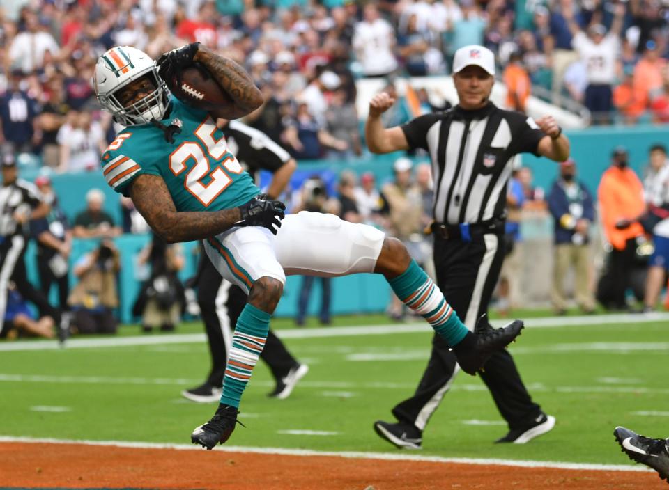 Miami Dolphins cornerback Xavien Howard (25) scores a touchdown as he jumps backwards into the end zone after intercepting a pass in the first quarter against the New England Patriots at Hard Rock Stadium in Miami Gardens, Jan. 9, 2022. 