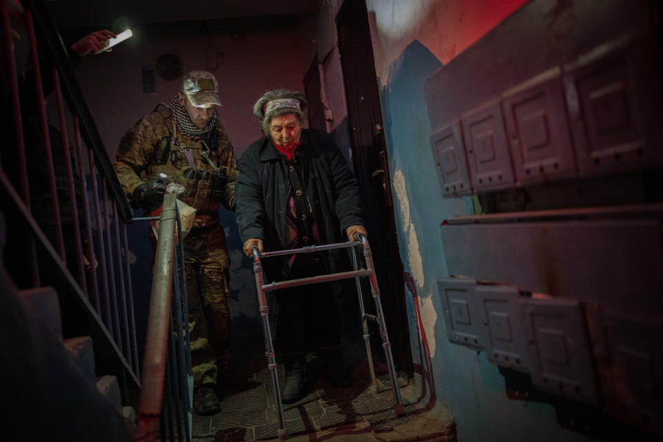 Elderly residents are evacuated from the southern city of Kherson, Ukraine, Sunday, Nov. 27, 2022. Shelling by Russian forces struck several areas in eastern and southern Ukraine overnight as utility crews continued a scramble to restore power, water and heating following widespread strikes in recent weeks. (AP Photo/Bernat Armangue)