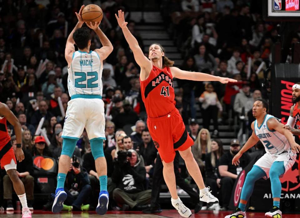 Charlotte Hornets guard Vasa Micic (22) shoots the ball as Toronto Raptors center Kelly Olynyk (41) defends in the first half at Scotiabank Arena.