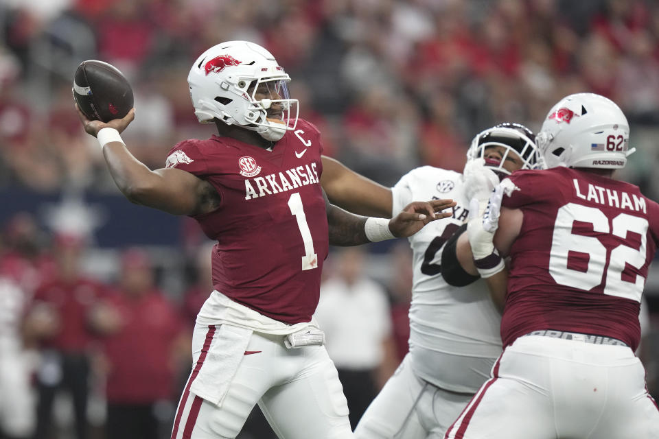 Arkansas quarterback KJ Jefferson (1) passes with blocking from offensive lineman Brady Latham (62) against Texas A&M defensive lineman Walter Nolen (0) during the first half of an NCAA college football game, Saturday, Sept. 30, 2023, in Arlington, Texas. (AP Photo/LM Otero)