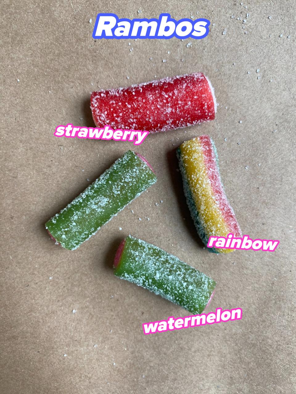 Four pieces of sugar-coated candy on a brown background