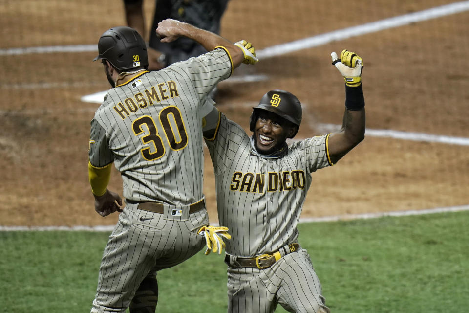 San Diego Padres' Jurickson Profar, right, celebrates his two-run home run with Eric Hosmer during the fourth inning of a baseball game against the Los Angeles Angels, Wednesday, Sept. 2, 2020, in Anaheim, Calif. (AP Photo/Jae C. Hong)