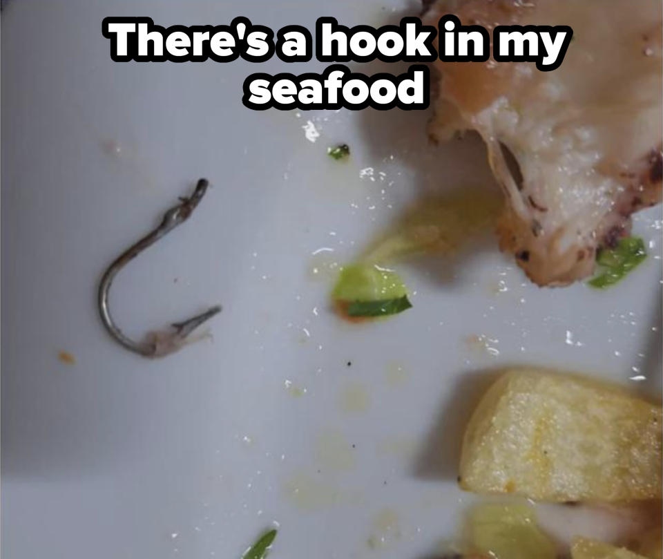 Partial fish, fries, and a small fishbone on a white plate