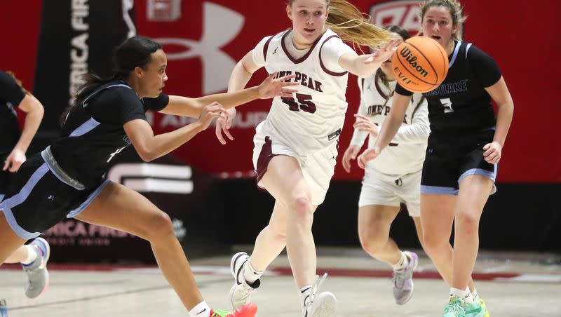 Westlake’s Jada Willis and Lone Peak’s Sarah Bartholomew reach for the ball during a 6A girls quarterfinal basketball game at the Huntsman Center in Salt Lake City on Monday, Feb. 26, 2024. Lone Peak won 59-50.