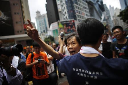 A pro-democracy protester argues with a pro-Beijing demonstrator (not pictured) as people block areas around the government headquarters building in Hong Kong, October 1, 2014. REUTERS/Carlos Barria