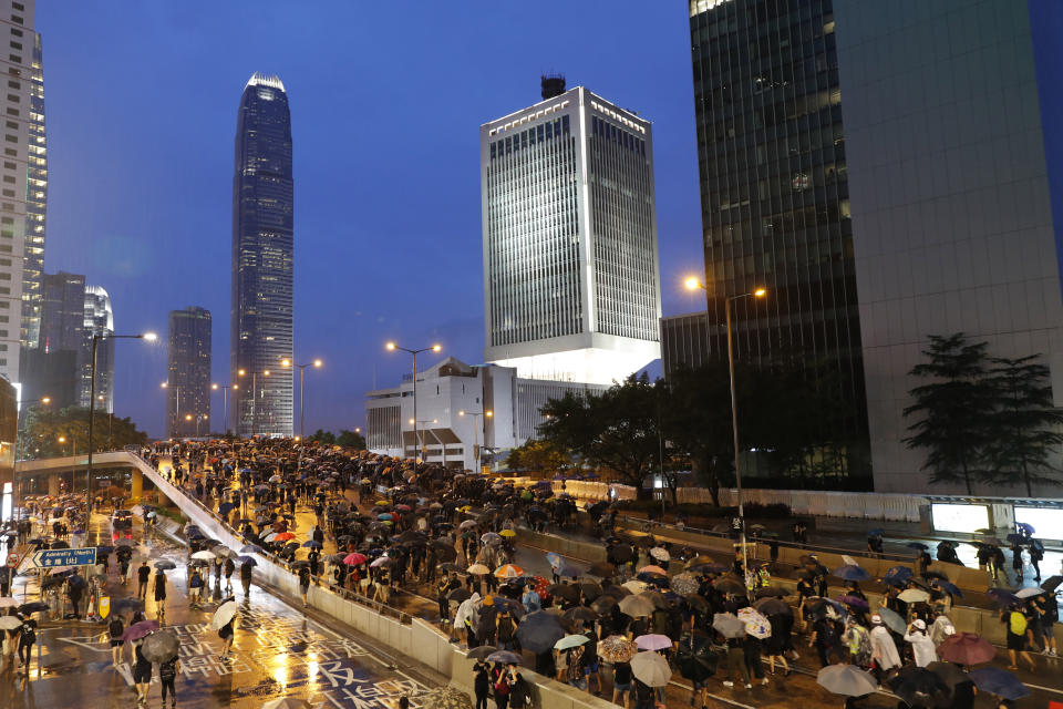 Protesters march in the rain in Hong Kong Sunday, Aug. 18, 2019. Heavy rain fell on tens of thousands of umbrella-toting protesters Sunday as they marched from a packed park and filled a major road in Hong Kong, where mass pro-democracy demonstrations have become a regular weekend activity this summer. (AP Photo/Vincent Thian)