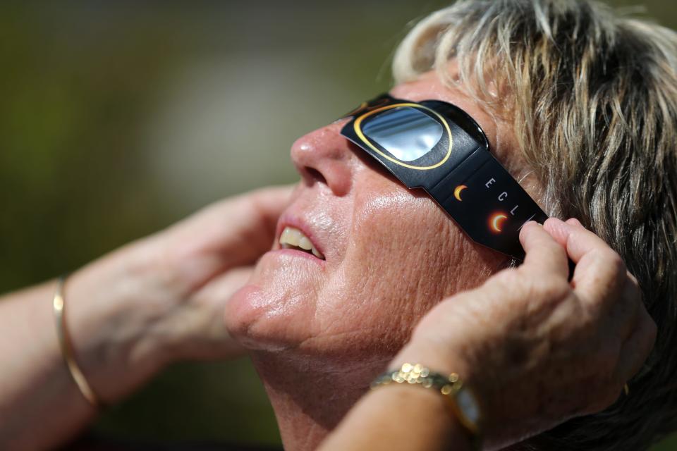 Chris Yager, of Hyde Park, views the total solar eclipse at a watch party sponsored by The Enquirer on Aug. 21, 2017, at Washington Park.
