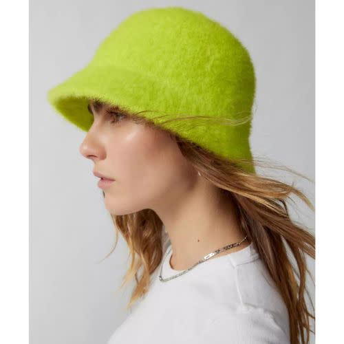 model wearing neon green fuzzy bucket hat