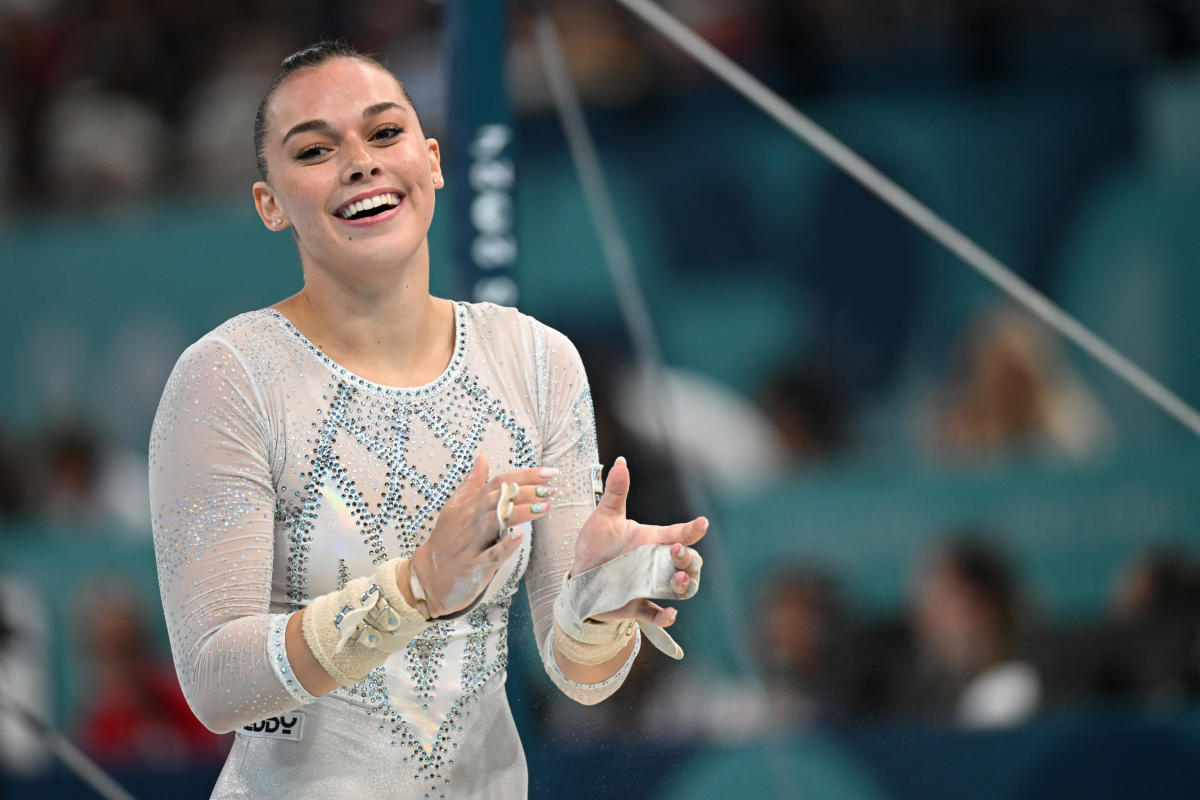 2024 Paris Olympics Italian gymnast poses with giant wheels of cheese