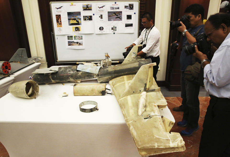 FILE - In this June 19, 2018 file photo, photographers take pictures of what U.A.E. officials described as an Iranian Qatef drone captured on the battlefield in Yemen during a news conference in Abu Dhabi, United Arab Emirates. Iran-backed Houthi rebels increasingly deploy drones in Yemen’s brutal civil war. Neighboring Saudi Arabia, which has been battling the rebels since 2015, said drones attacked an oil pipeline, targeting two pumping stations west of its capital, Riyadh, on Tuesday, May 14, 2019. (AP Photo/Jon Gambrell, File)