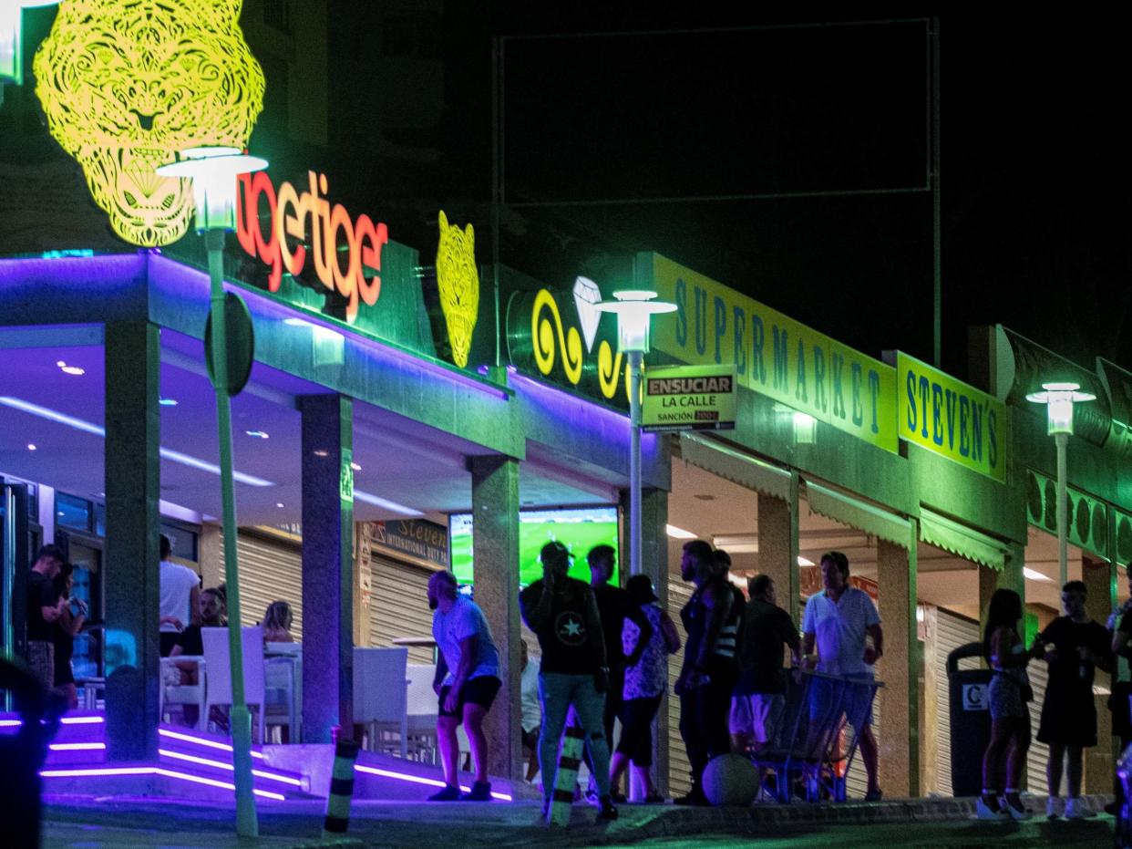 People queue at a pub of Punta Ballena area in Magaluf: EPA