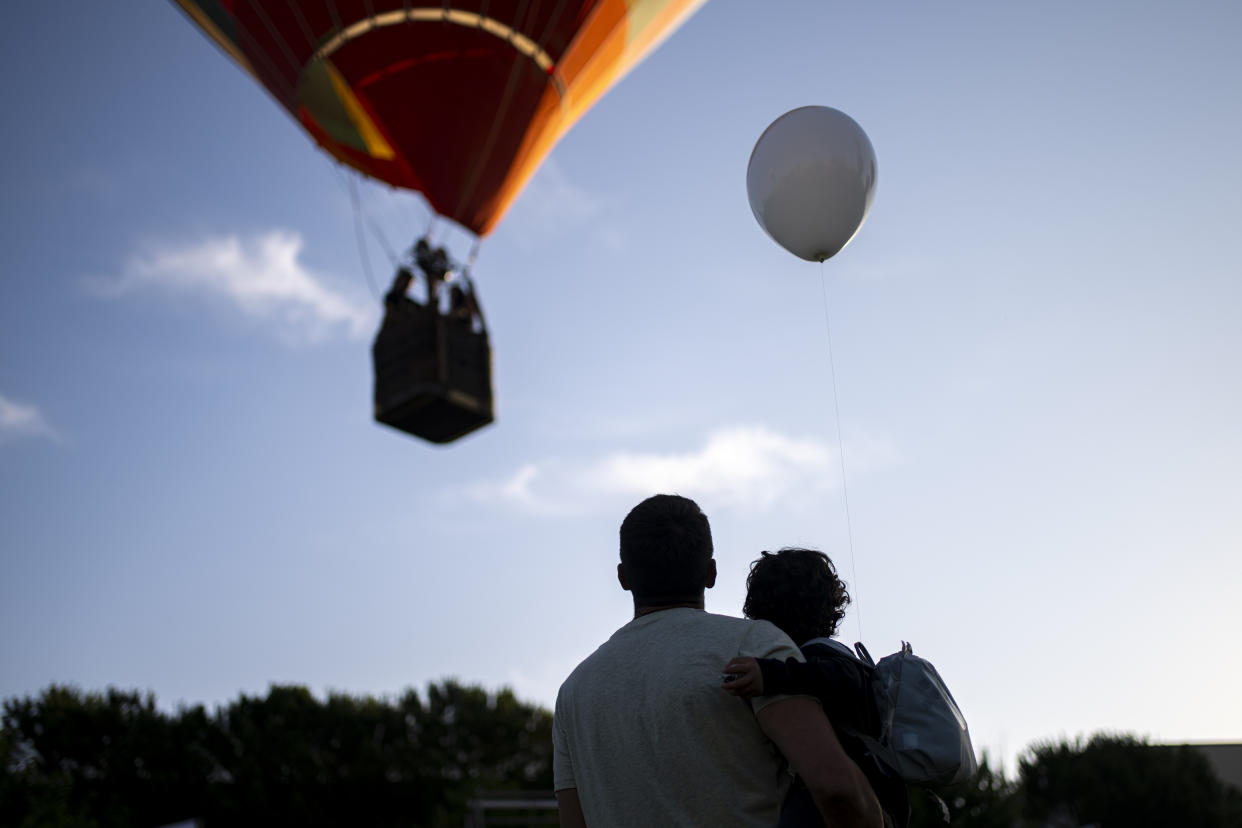  Spectators gaze at the hot-air balloons during the festival on July 11.