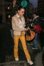 <p>In a white top, tan jacket, yellow snakeskin pants, <a href="https://www.bergdorfgoodman.com/p/by-far-mara-suede-shoulder-bag-prod151790095" rel="nofollow noopener" target="_blank" data-ylk="slk:By Far's Mara bag;elm:context_link;itc:0;sec:content-canvas" class="link ">By Far's Mara bag</a>, white sneakers, brown shades, and gold jewelry.</p>