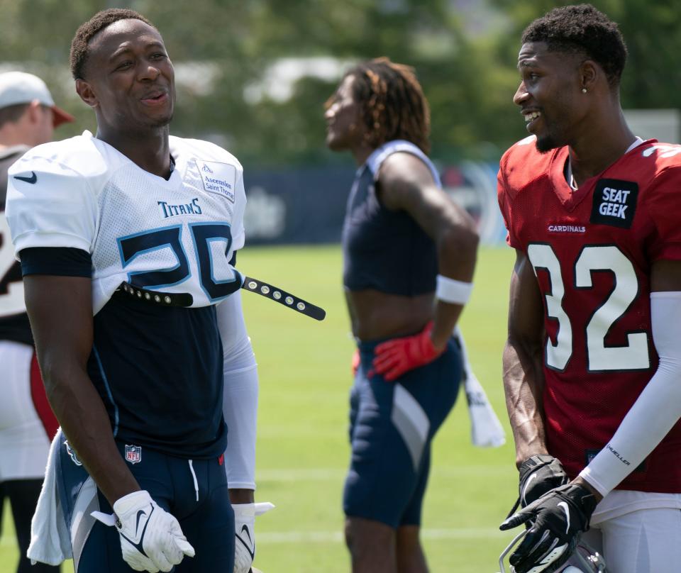 Aug 24, 2022; Nashville, Tennessee;  Tennessee Titans safety Theo Jackson (29) laughs with Arizona Cardinals wide receiver JaVonta Payton (32) after a joint training camp practice at Ascension Saint Thomas Sports Park.