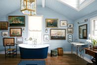 <p>Themes work especially well in interiors when inspired by your own passions and interests, but with a design-savvy touch. This primary bathroom designed by <a href="https://www.alexandraangle.com/" rel="nofollow noopener" target="_blank" data-ylk="slk:Alexander Angle;elm:context_link;itc:0;sec:content-canvas" class="link ">Alexander Angle</a> is the perfect example. His client had a large collection of ship paintings, so they decided to anchor the main bath with them. The vintage trunks, light blue walls, and gold pendant are tasteful nods to maritime adventure. </p>