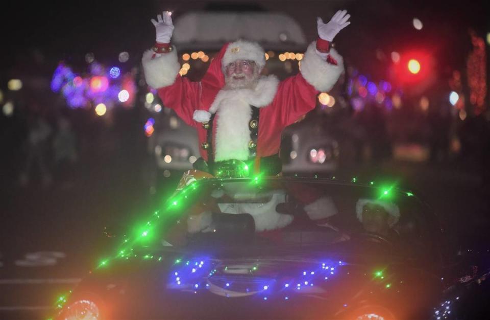 Santa Claus waves to the crowd during the Annual Los Banos Christmas Parade on Friday, Dec. 3, 2021 in Los Banos, Calif.