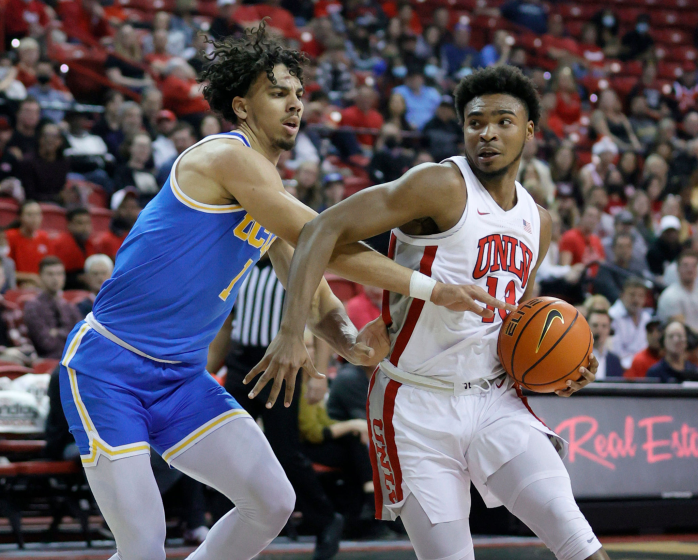 UNLV's Bryce Hamilton drives against UCLA's Jules Bernard on Nov. 27, 2021, in Las Vegas.