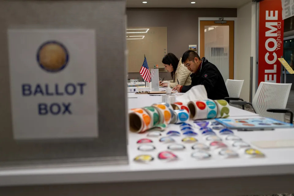 People participate in voting in the upcoming midterm elections at a Native Alaskan voting station