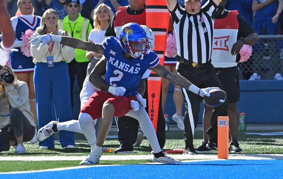 Kansas Jayhawks wide receiver Lawrence Arnold (2) stretches the ball over the goal line for a touchdown during the first half against the UCF Knights at David Booth Kansas Memorial Stadium on Oct. 7, 2023.