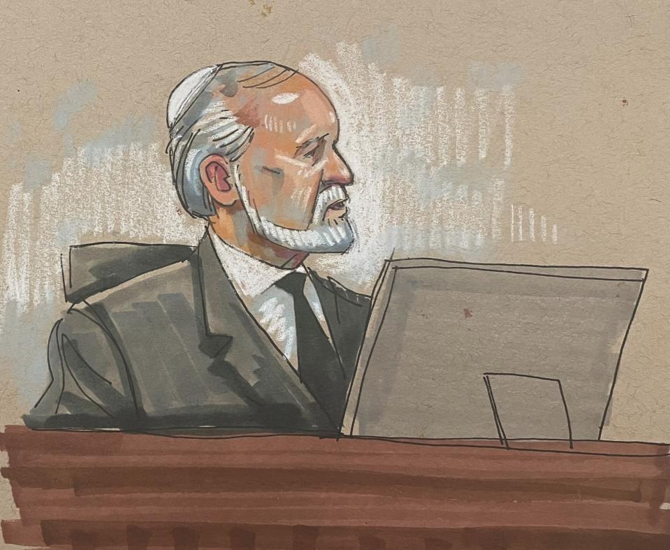 In this courtroom sketch, Rabbi Jeffrey Myers, who leads the Tree of Life Congregation, testifies in the federal trial for Robert Bowers, the suspect in the 2018 synagogue massacre, on Tuesday, May 30, 2023, in Pittsburgh. Bowers could face the death penalty if convicted of some of the 63 counts he faces in the shootings, which claimed the lives of worshippers from three congregations who were sharing the building, Dor Hadash, New Light and Tree of Life. (David Klug via AP)