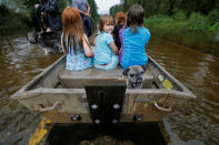 Iva Williamson, 4, peers behind her as she joins neighbors and pets in fleeing rising flood waters in the aftermath of Hurricane Florence in Leland, North Carolina, U.S., September 16, 2018. REUTERS/Jonathan Drake