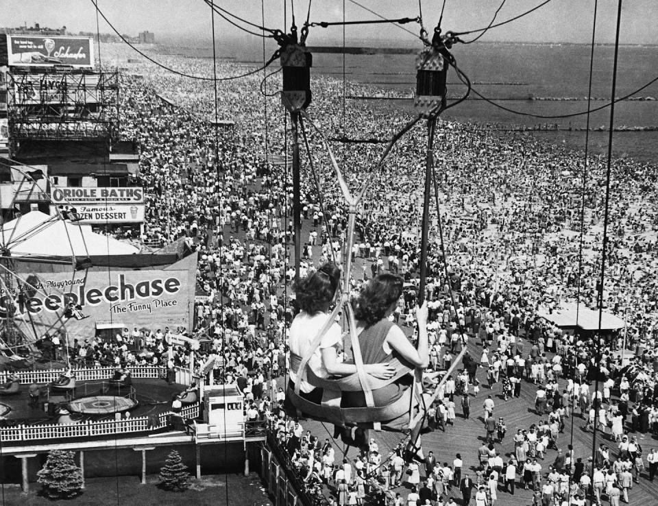 Passengers on the Parachute Jump ride see throngs of people on the boardwalk and beach at the Coney Island Amusement Park in Brooklyn, N.Y., in 1957. <a href="http://www.apimages.com/metadata/Index/Watchf-Associated-Press-Domestic-News-New-York-/d91ad1ddf130445c9d2bd4c0e0fe9f7d/15/0" rel="nofollow noopener" target="_blank" data-ylk="slk:AP Photo;elm:context_link;itc:0;sec:content-canvas" class="link ">AP Photo</a>