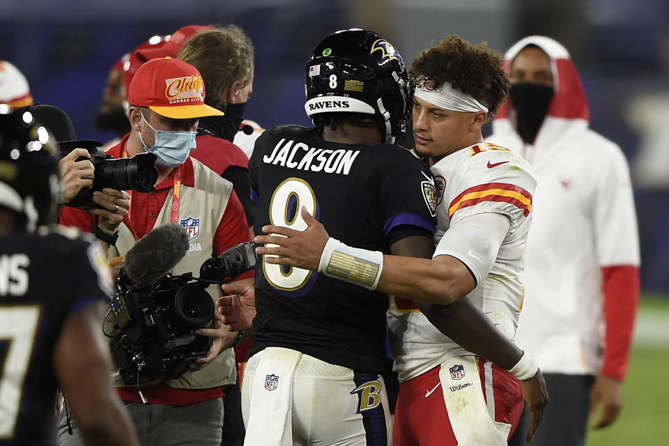FILE - Baltimore Ravens quarterback Lamar Jackson, center, and Kansas City Chiefs quarterback Patrick Mahomes, right, embrace after an NFL football game, Sept. 28, 2020, in Baltimore. Past NFL MVPs Jackson and Mahomes will face each other in the AFC championship game in Baltimore on Sunday, Jan. 28, 2024. (AP Photo/Gail Burton, File)