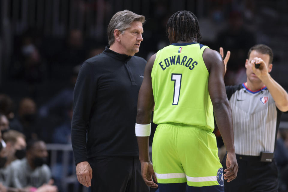 Minnesota Timberwolves coach Chris Finch talks with forward Anthony Edwards (1) during the first half of the team's NBA basketball game against the Atlanta Hawks Wednesday, Jan. 19, 2022, in Atlanta. (AP Photo/Hakim Wright Sr.)