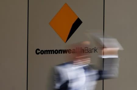 A man leaves the Commonwealth Bank of Australia building in central Sydney August 14, 2013. REUTERS/Daniel Munoz/File Photo