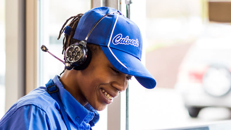 Man operating drive through with Culver's blue hat