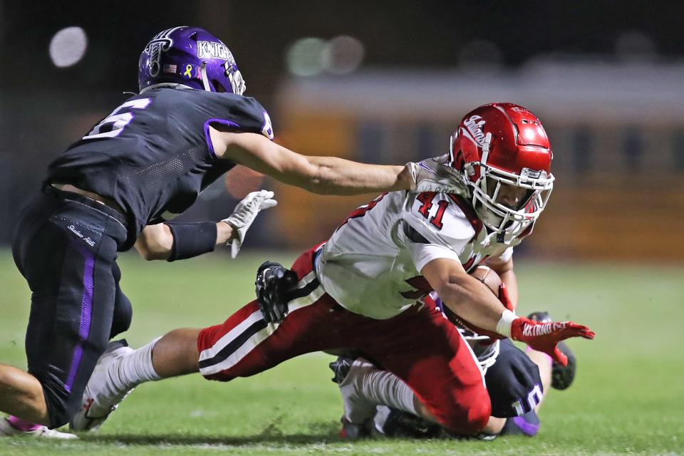 Jordan Johnson (41) of Palm Springs is tackled by Kaleb Marquez (6) and Travis Bloch (10) of Shadow Hills in Indio, Calif., on Friday, October 14, 2022.