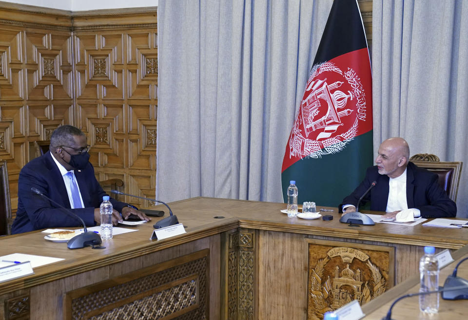 U.S. Defense Secretary Lloyd Austin, left, meets Afgan President Ashraf Ghani at the presidential palace in Kabul, Afghanistan, Sunday, March 21, 2021. Austin arrived in Kabul on his first trip to Afghanistan as Pentagon chief, amid swirling questions about how long American troops will remain in the country. (Presidential Palace via AP)