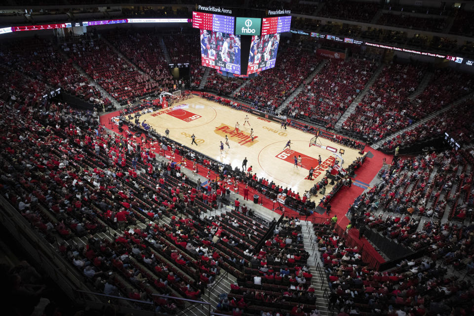 Fans watch Northwestern play against Nebraska during the second half of an NCAA college basketball game Saturday, Feb. 5, 2022, in Lincoln, Neb. Northwestern defeated Nebraska 87-63. As Nebraska grinds through one of the worst men's basketball seasons in program history under third-year coach Fred Hoiberg, the empty seats at Pinnacle Bank Arena are growing in number. (AP Photo/Rebecca S. Gratz)