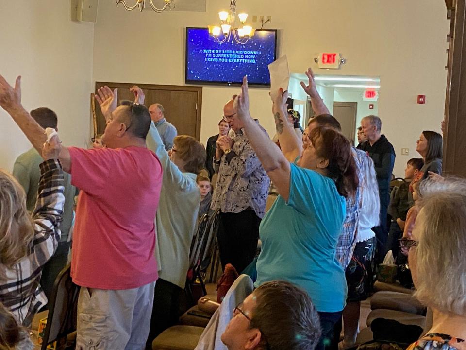 Members of Freedom Life Church's congregation participate in a Sunday service held at the Towne Square Community Centre in downtown Winchester. The church's longtime home along Greenville Pike was destroyed Thursday by a tornado.