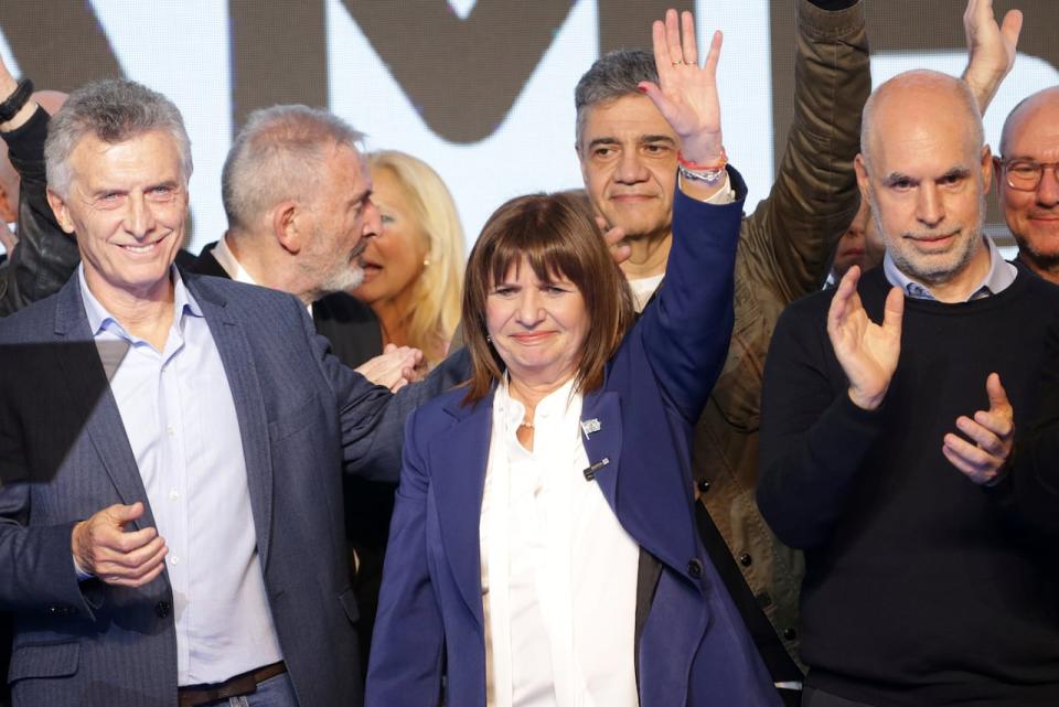 Presidential candidate Patricia Bullrich (center), former hopeful Horacio Rodríguez Larreta (right), with the United for Change coalition, and Argentina's former president Mauricio Macri (left) celebrate at their campaign headquarters after polling stations closed during primary elections in Buenos Aires, Argentina on Aug. 13, 2023.