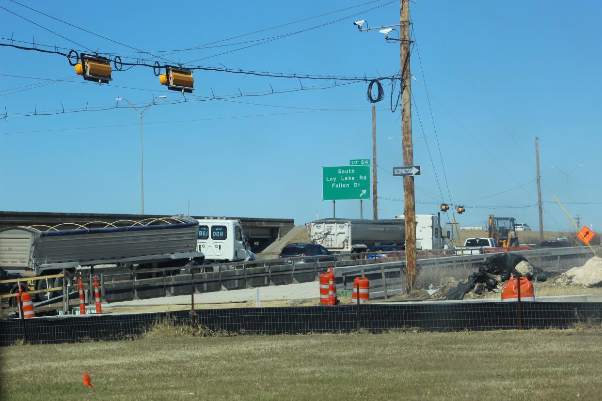 Trucks pass through the intersection of US Highway 75 and US Highway 82 service road intersections near construction areas on the highways on Feb. 14, 2022.