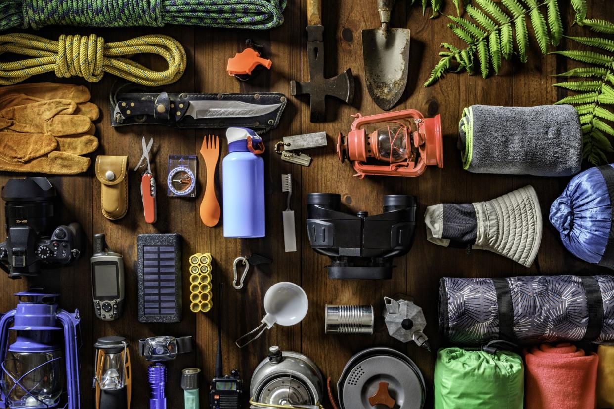 Camping and hiking themes: Top view of large group of gear, equipment and accessories for mountain trips.