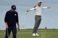 Team Europe's Sergio Garcia reacts after teammate Team Europe's Jon Rahm makes a putt during a four-ball match the Ryder Cup at the Whistling Straits Golf Course Saturday, Sept. 25, 2021, in Sheboygan, Wis. (AP Photo/Jeff Roberson)