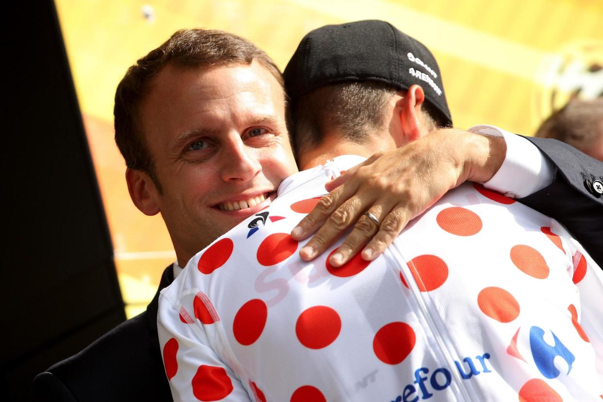 Warren Barguil of France riding for Team Sunweb stands on the podium in the king of the mountain jersey and talks with French President Emmanuel Macron: Chris Graythen/Getty Images