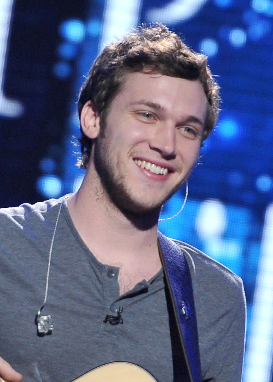 close up of Phillip on stage with a guitar