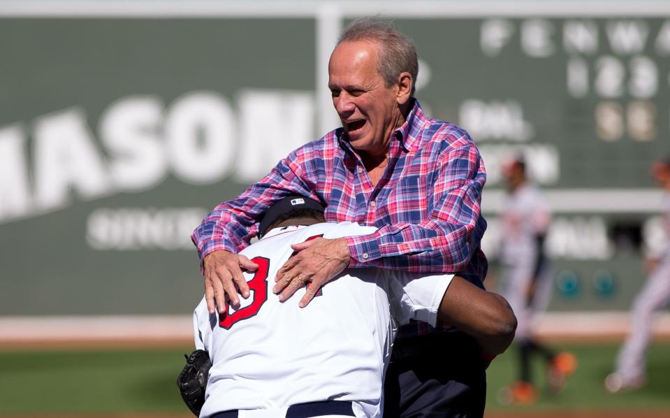 BOSTON, MA - SEPTEMBER 27: David Ortiz #34 of the Boston Red Sox lifts up Larry Lucchino as Lucchino was being honored for his last home game as Red Sox CEO/President before a game against the Baltimore Orioles  Fenway Park on September 27, 2015 in Boston, Massachusetts. The Red Sox won 2-0. (Photo by Rich Gagnon/Getty Images)
