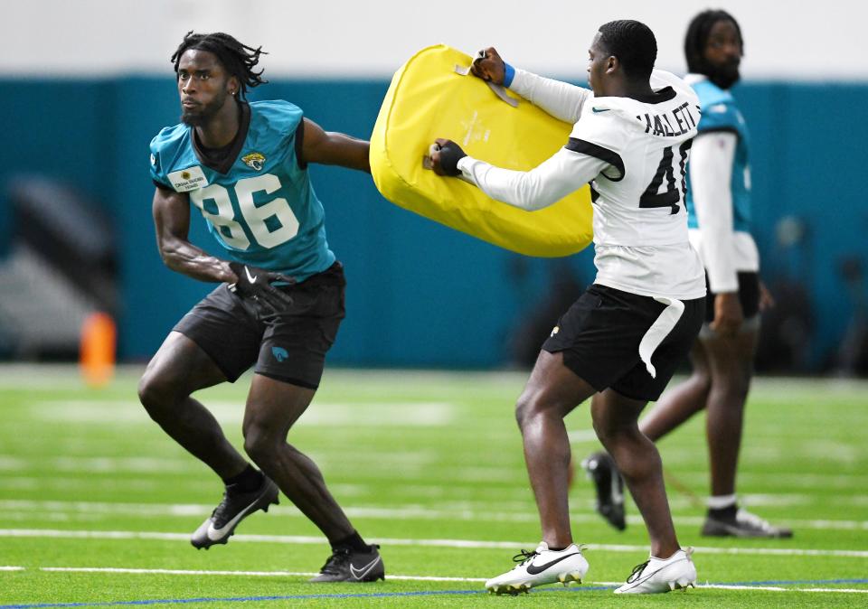 Jacksonville Jaguars wide receiver David White Jr. (86) runs a drill around cornerback Erick Hallett II (40) during Friday's rookie minicamp session. The Jacksonville Jaguars held their first day of rookie minicamp inside the covered field at the Jaguars performance facility in Jacksonville, Florida Friday, May 10, 2024. [Bob Self/Florida Times-Union]