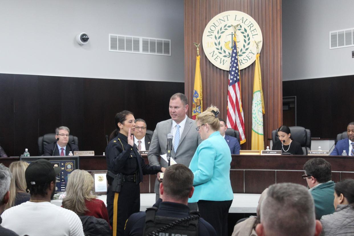 New Jersey Assemblywoman Carol Murphy, D-Mount Laurel, administers the oath of office to the new Mount Laurel police chief, Judy Lynn Schiavone, the first woman to hold that township post. Holding the Bible is Clint Kelly,  Schiavone's husband.