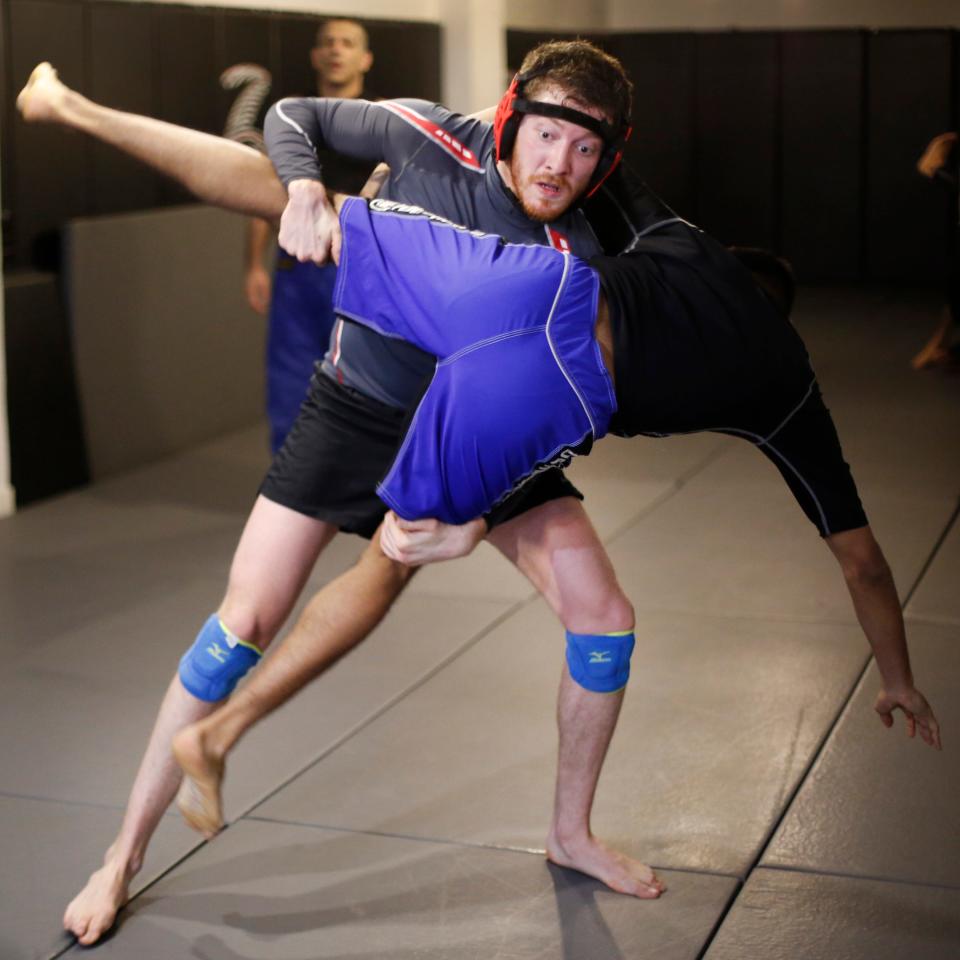 Sawyer Spielberg (left) takes down Antonio Sigillo at Radical MMA NYC in a 2016 AP photo.