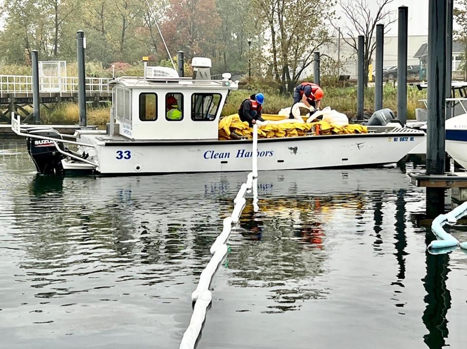 Clean Harbors Cooperative provides a flotation device that contains hazmat spills, in the wake of a fire that sank a boat in the Carteret Municipal Marina last October.