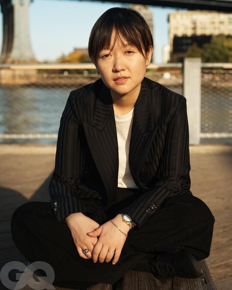 Jacket by Loro Piana. T-shirt, pants, and sneakers by The Row. Watch by Rolex. Bracelet by Miansai. Ring (on left hand), her own. Rings (on right hand) by Starling.