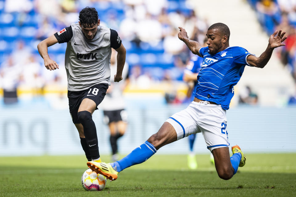 Augsburg's Ricardo Pepi, left, and Hoffenheim's Kevin Akpoguma challenge for the ball during the German Bundesliga soccer match between TSG 1899 Hoffenheim and FC Augsburg in Sinsheim, Germany, Saturday, Aug. 27, 2022. (Tom Weller/dpa via AP)