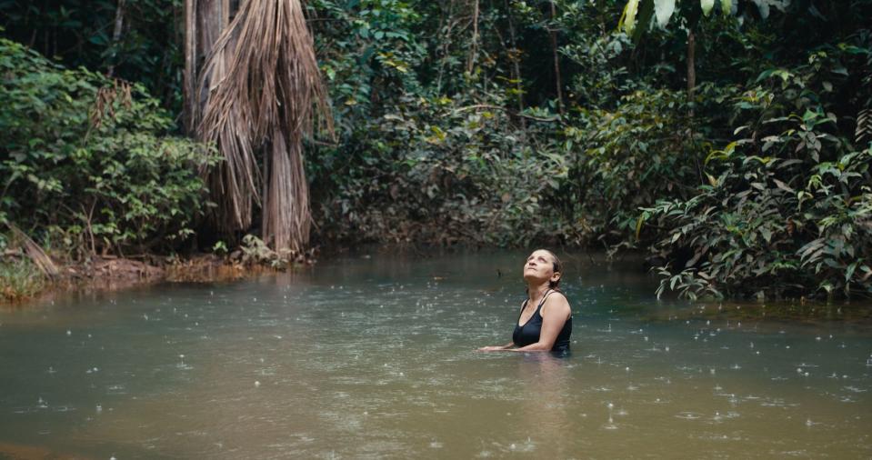 Neidinha Bandeira, an environmental activist, bathes in the river in the Amazon rainforest.<span class="copyright">Alex Pritz—Amazon Land Documentary</span>