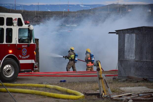 Firefighters in Iqaluit work to extinguish a fire. In 2020, Nunavut experienced 131 fires, which resulted in two deaths, six injuries and $5.7 million in damages, according to the territorial fire marshal's annual report. (Patrick Nagle/CBC  - image credit)